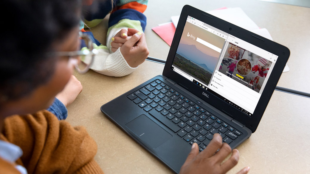 A young student in a classroom enjoying the benefits of the Snap screen functionality on a Windows 11 PC