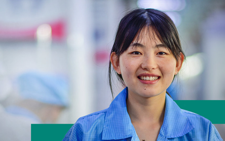 A female factory supervisor smiling