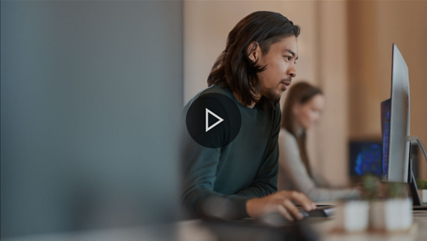 Two people working on desktop computers